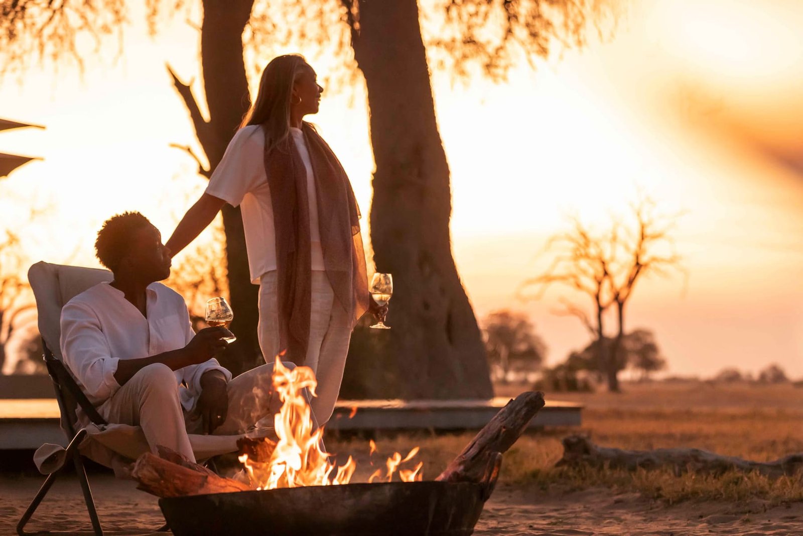 A couple by the fire at sunset